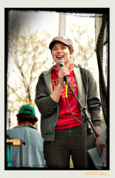 Director Cassandra Hage announces the first class of Earth Day Action Grant recipients on stage at the 2013 St. Louis Earth Day Festival.